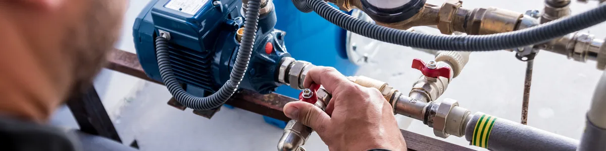 Technician working on boiler piping and valves