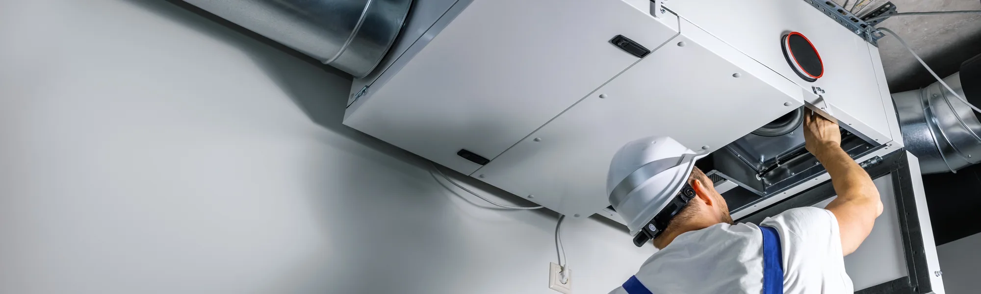 HVAC technician servicing an air handler unit