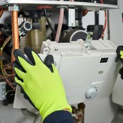 Technician servicing a wall mounted boiler